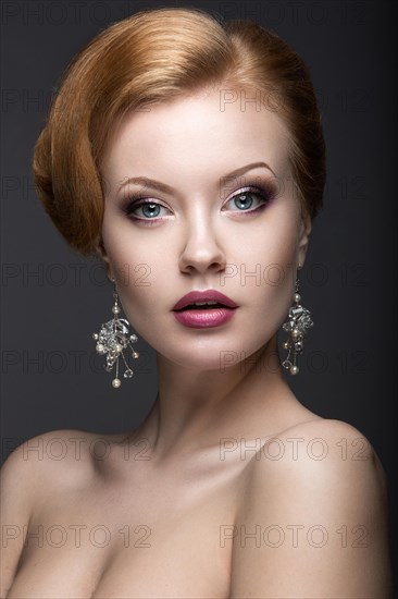 Beautiful girl with bright fashionable make-up and long thick hair. Beauty face. Photo taken in the studio