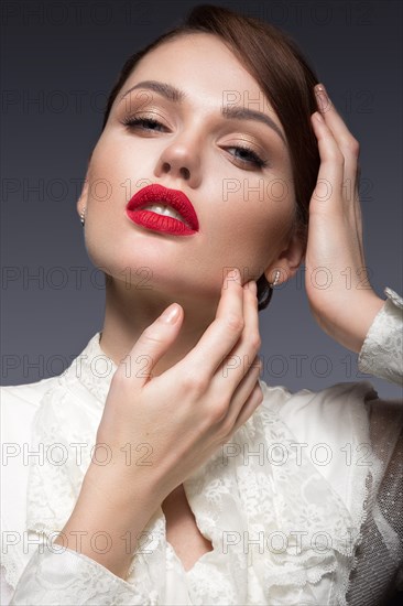 Beautiful girl with red lips in white clothes in the form of retro. Beauty face. Picture taken in the studio