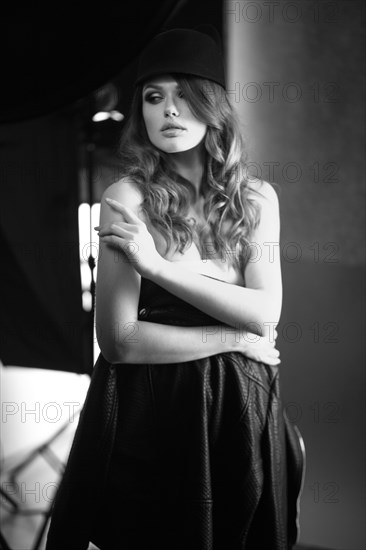 Beautiful girl posing on a photo shoot in the studio. Black and white image