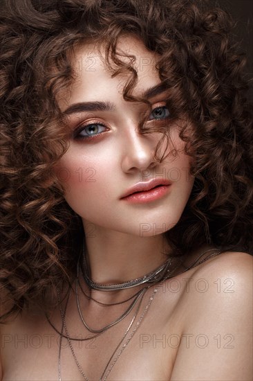 Beautiful brunette girl with a perfectly curly hair