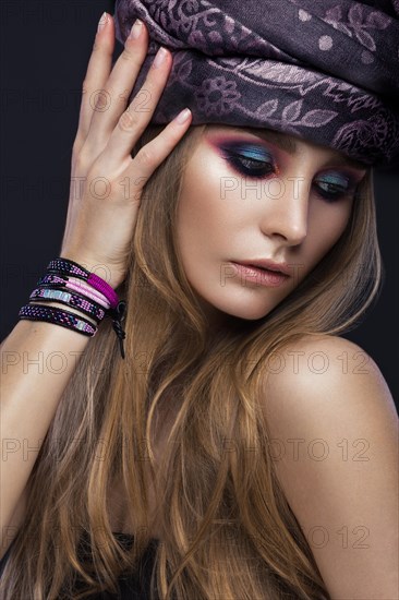 Beautiful fashion girl in a scarf and bracelets boho style. Beauty face
