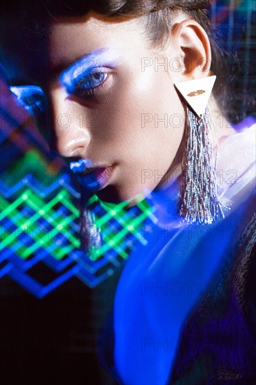 Fashion model beautiful girl in fashionable clothes in ultraviolet light