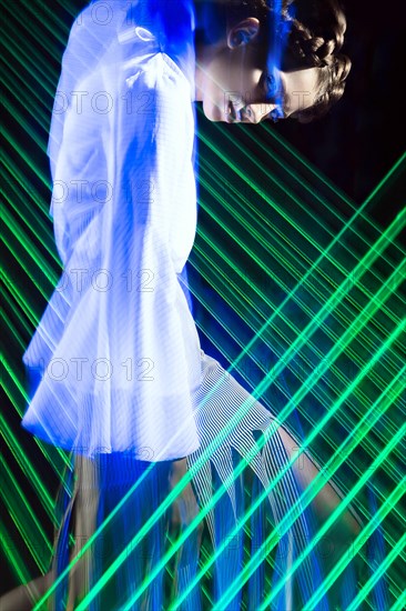 Fashion model beautiful girl in fashionable clothes in ultraviolet light