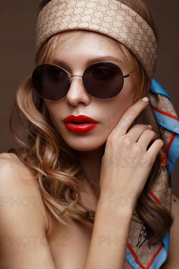 Beautiful girl in stylish clothes with sunglasses and red sexy lips. Beauty face. Photo taken in the studio