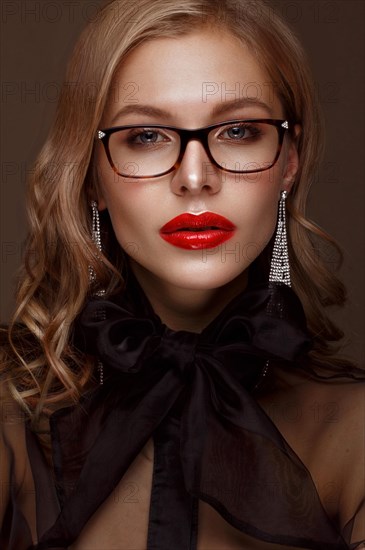 Beautiful girl in stylish clothes with glasses for vision and red sexy lips. Beauty face. Photo taken in the studio