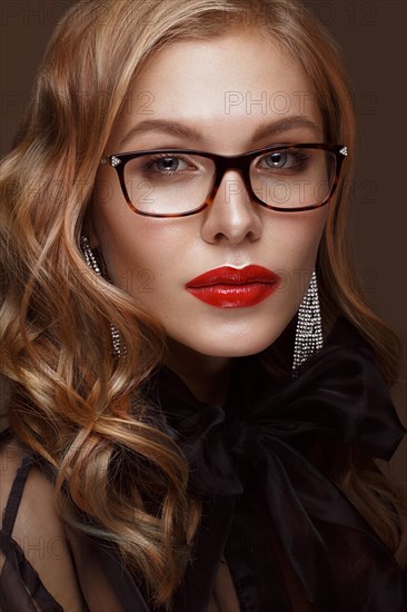 Beautiful girl in stylish clothes with glasses for vision and red sexy lips. Beauty face. Photo taken in the studio