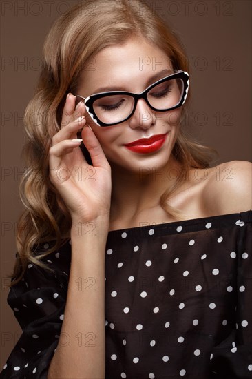 Beautiful girl in stylish clothes with glasses for vision and red sexy lips. Beauty face. Photo taken in the studio