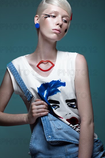 Fashionable girl with natural make-up in clothes with a picture in the style of pop art