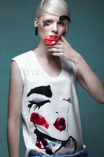 Fashionable girl with natural make-up in clothes with a picture in the style of pop art