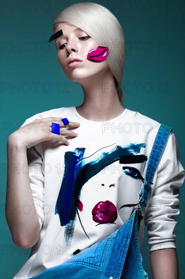 Fashionable girl with natural make-up in clothes with a picture in the style of pop art