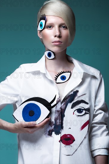 Fashionable girl with natural make-up in clothes with a picture in the style of pop art