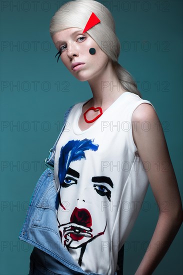 Fashionable girl with natural make-up in clothes with a picture in the style of pop art