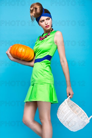 Beautiful fashionable woman an unusual hairstyle in bright clothes and colorful accessories. Cuban style. Picture taken in the studio on a bright background