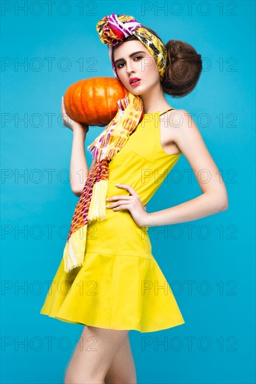 Beautiful fashionable woman an unusual hairstyle in bright clothes and colorful accessories. Cuban style. Picture taken in the studio on a bright background