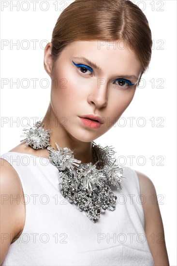 Beautiful fashionable girl with the blue arrows on the eyes