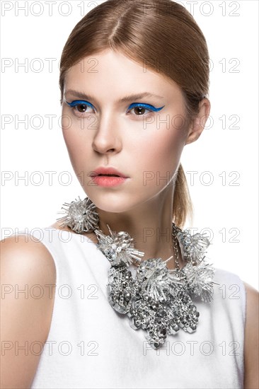 Beautiful fashionable girl with the blue arrows on the eyes