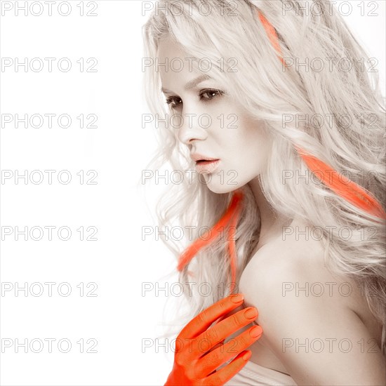 Art fashion girl with white skin in the form of albinos with red arms and a lock of hair. Creative image of beauty. Photos shot in studio