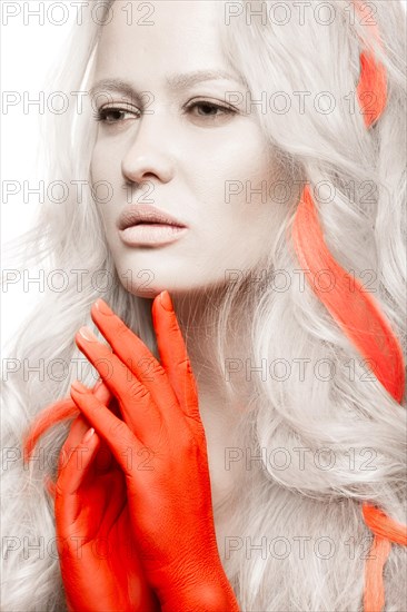 Art fashion girl with white skin in the form of albinos with red arms and a lock of hair. Creative image of beauty. Photos shot in studio