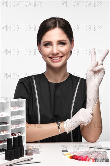 Manicurist in working form with tools in hand. Nail photo content