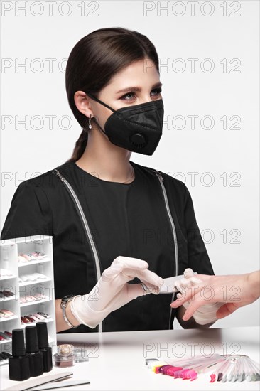 Manicurist in working form with tools in hand. Nail photo content