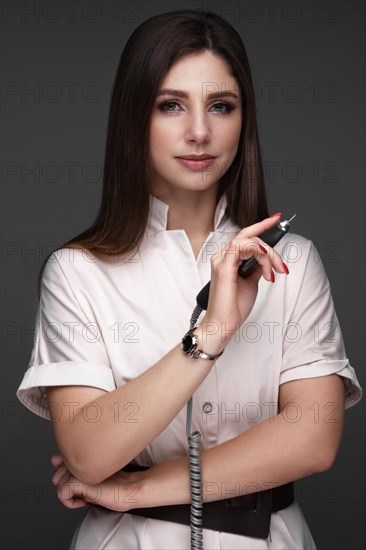 Manicurist in working form with tools in hand. Nail photo content