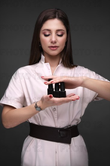 Manicurist in working form with tools in hand. Nail photo content