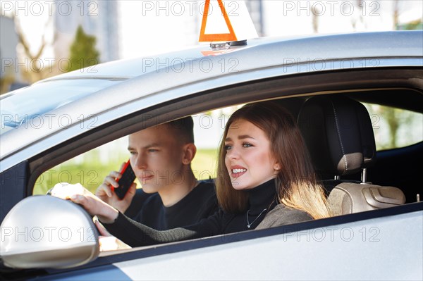 The driver is an auto school instructor and a female student on an examination car. Lesson at the circuit