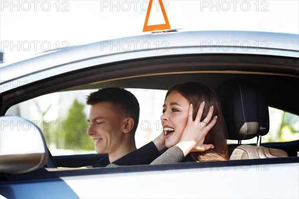 The driver is an auto school instructor and a female student on an examination car. Lesson at the circuit