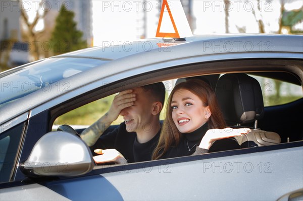 The driver is an auto school instructor and a female student on an examination car. Lesson at the circuit