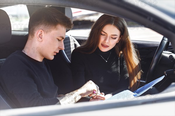 The driver is an auto school instructor and a female student on an examination car. Lesson at the circuit