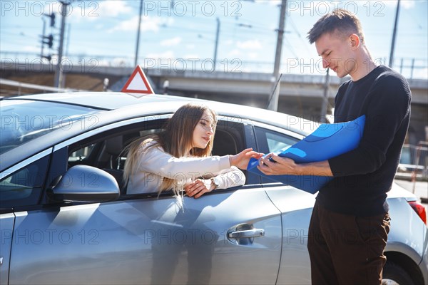 The driver is an auto school instructor and a female student on an examination car. Lesson at the circuit