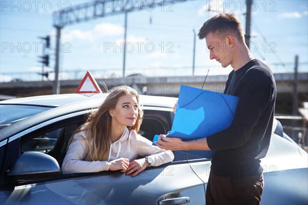 The driver is an auto school instructor and a female student on an examination car. Lesson at the circuit