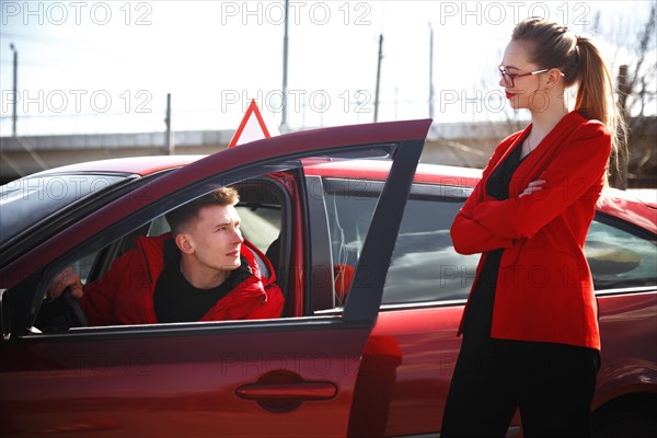 The driver is an auto school instructor and a female student on an examination car. Lesson at the circuit