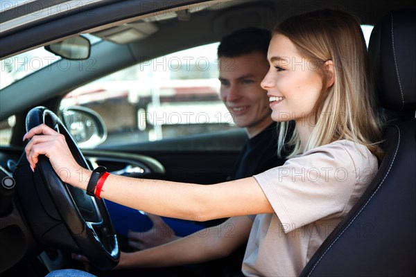 The driver is an auto school instructor and a female student on an examination car. Lesson at the circuit