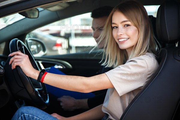 The driver is an auto school instructor and a female student on an examination car. Lesson at the circuit