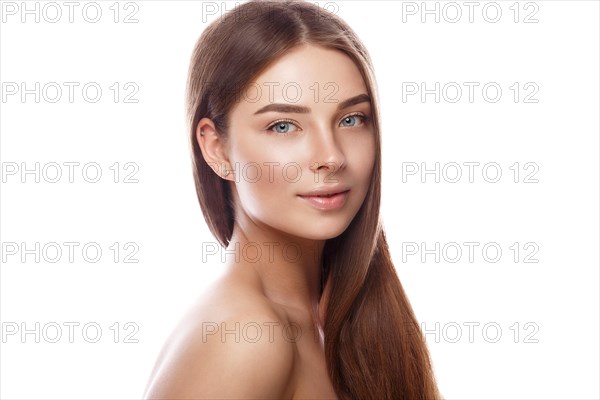 Beautiful young girl with a light natural make-up and perfect skin. Beauty face. Picture taken in the studio on a white background