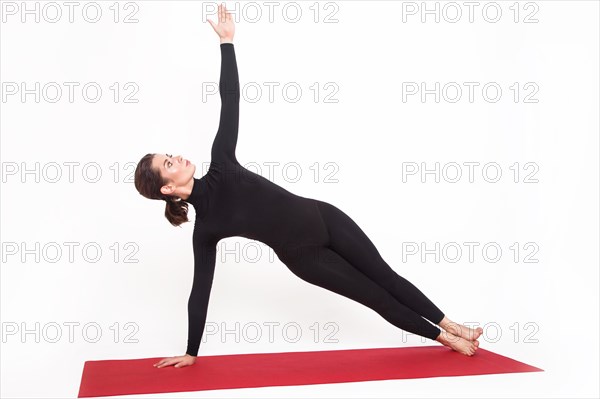 Beautiful athletic girl in black suit doing yoga. vasishthasana asana sage pose. Isolated on white background