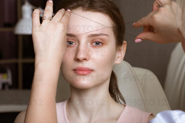 Permanent microblasting tattooing freckles to a woman in a beauty salon