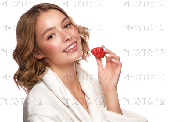 Beautiful tender young girl in a white coat with clean fresh skin posing in front of the camera. Beauty face. Skin care. Photo taken in studio on a white isolate background