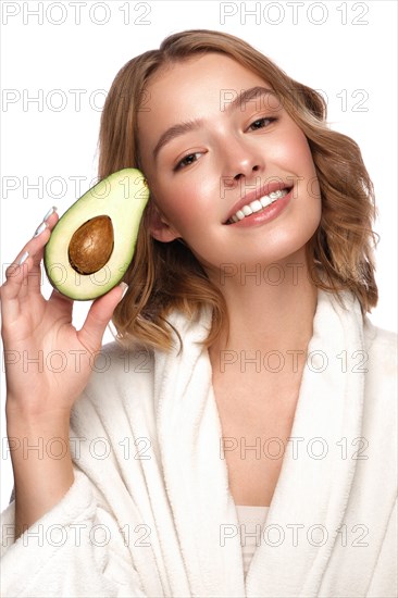 Beautiful tender young girl in a white coat with clean fresh skin posing in front of the camera. Beauty face. Skin care. Photo taken in studio on a white isolate background