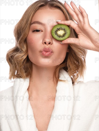 Beautiful tender young girl in a white coat with clean fresh skin posing in front of the camera. Beauty face. Skin care. Photo taken in studio on a white isolate background