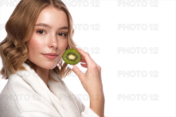 Beautiful tender young girl in a white coat with clean fresh skin posing in front of the camera. Beauty face. Skin care. Photo taken in studio on a white isolate background