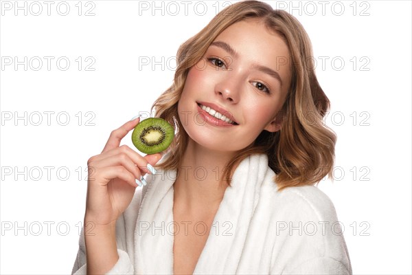 Beautiful tender young girl in a white coat with clean fresh skin posing in front of the camera. Beauty face. Skin care. Photo taken in studio on a white isolate background