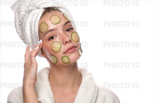 Beautiful tender young girl in a white towel with clean fresh skin posing in front of the camera. Beauty face. Skin care. Photo taken in studio on a white isolate background