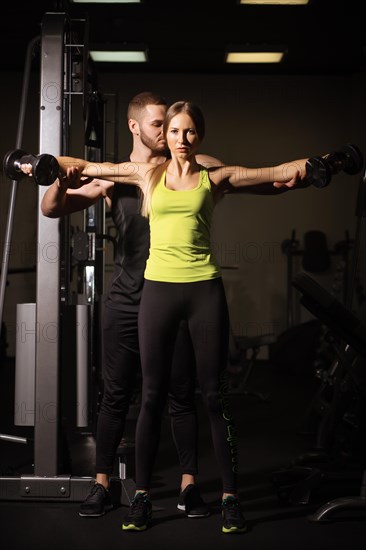 Sporty sexy man and woman with great abdominal muscles in black sportswear