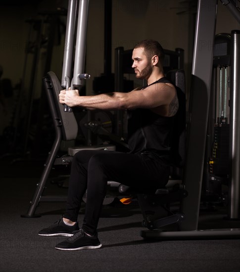 Sporty sexy men with great abdominal muscles in black sportswear