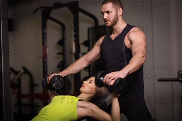 Sporty sexy man and woman with great abdominal muscles in black sportswear