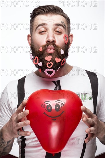 Funny bearded man with hearts Valentine's Day. Portrait shot in studio