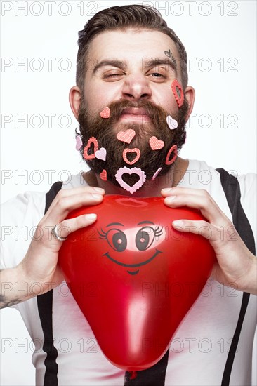 Funny bearded man with hearts Valentine's Day. Portrait shot in studio