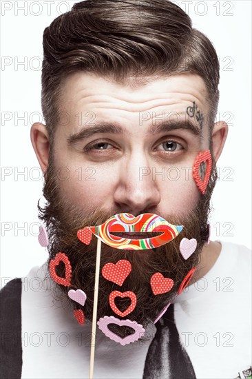 Funny bearded man with hearts Valentine's Day. Portrait shot in studio